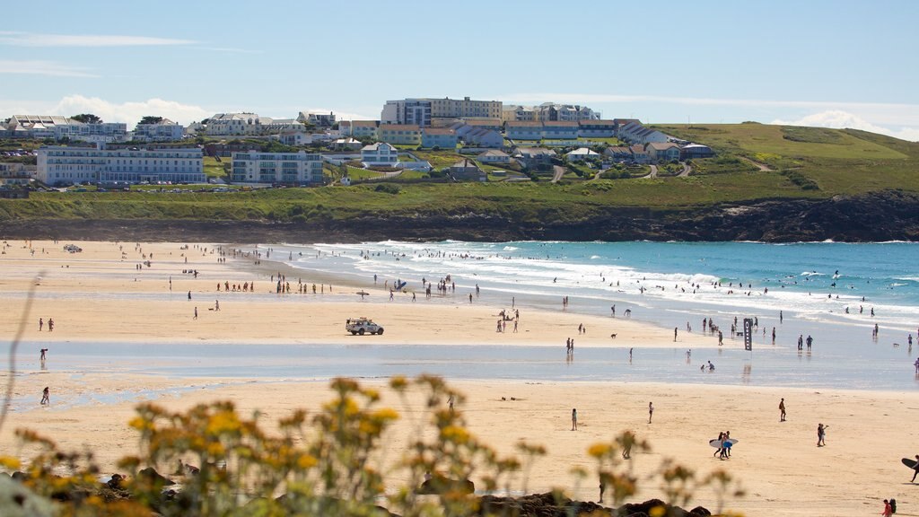 Fistral Beach showing a coastal town, a beach and rocky coastline