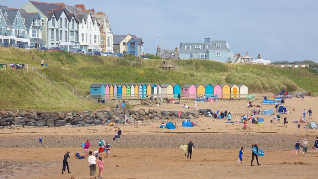 Bude Beach featuring a coastal town and a beach as well as a large group of people