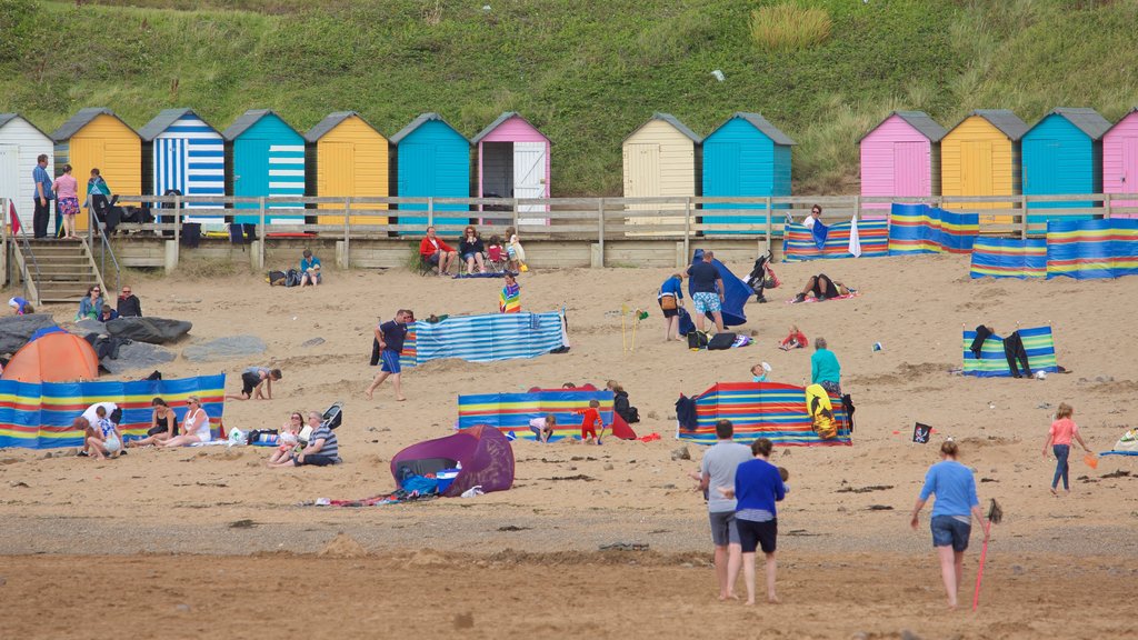 Bude Beach showing a sandy beach as well as a small group of people