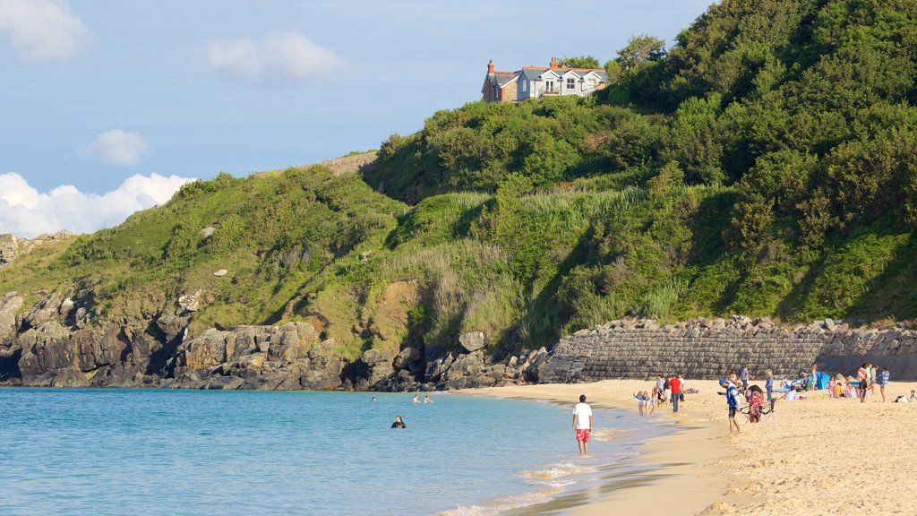 Porthminster Beach showing a beach, a coastal town and swimming