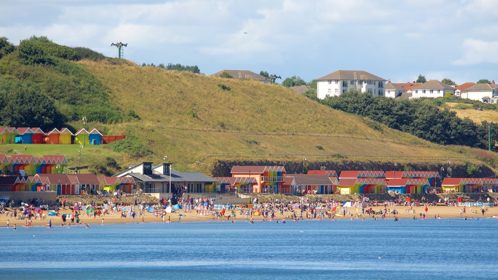 North Bay Beach showing a beach and a coastal town as well as a large group of people