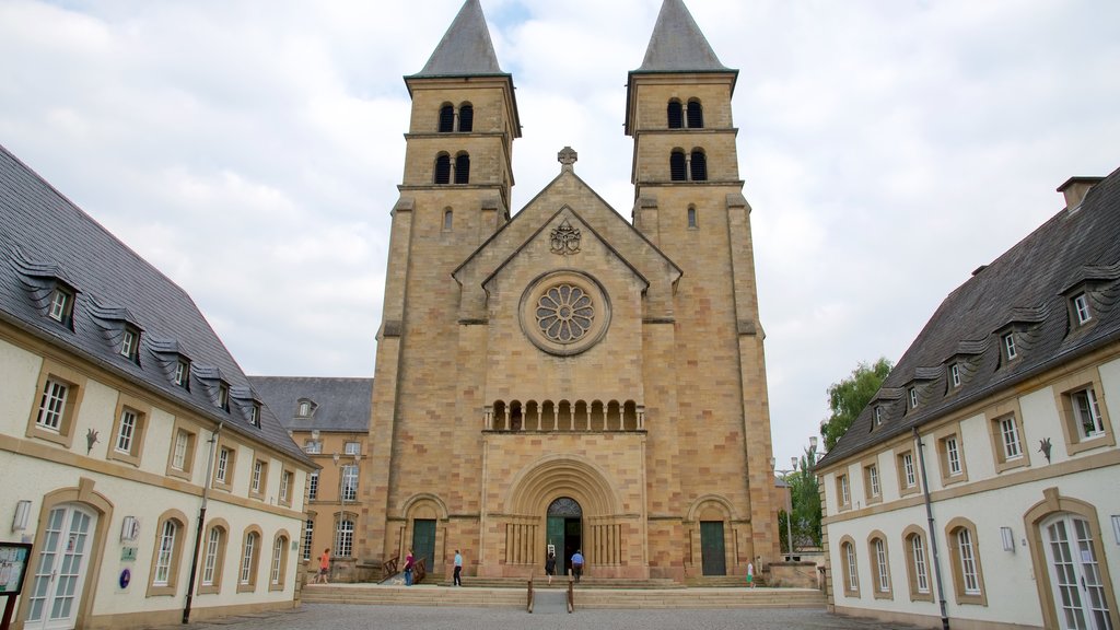 Echternach featuring a church or cathedral as well as a small group of people