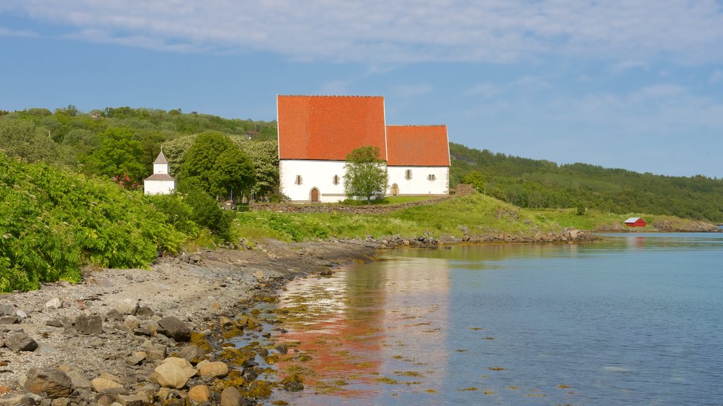 Trondenes Church featuring a church or cathedral and rocky coastline