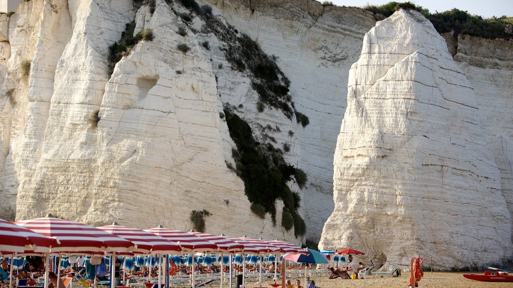 Pizzomuou which includes rocky coastline and a sandy beach