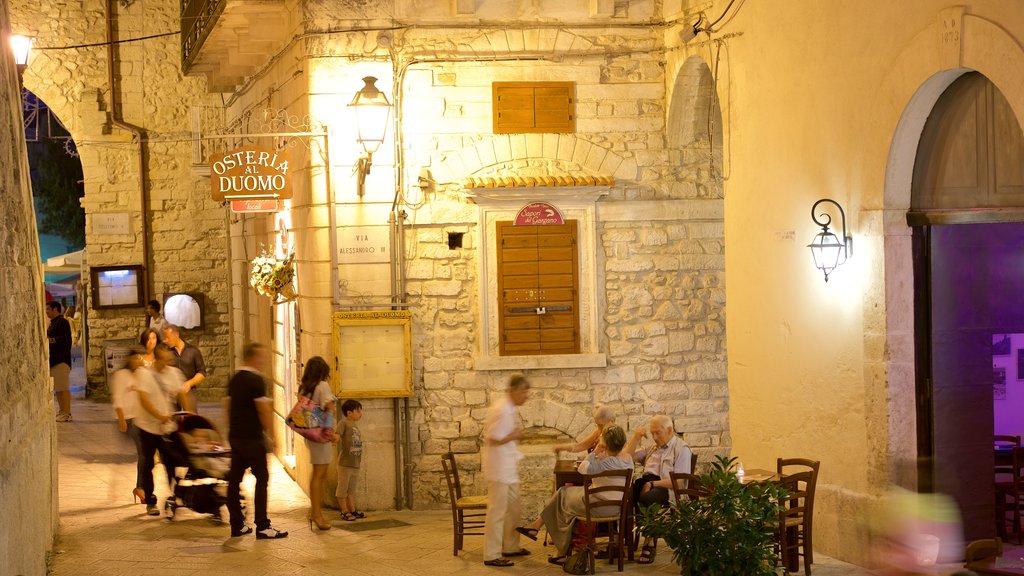 Vieste featuring night scenes and outdoor eating as well as a small group of people