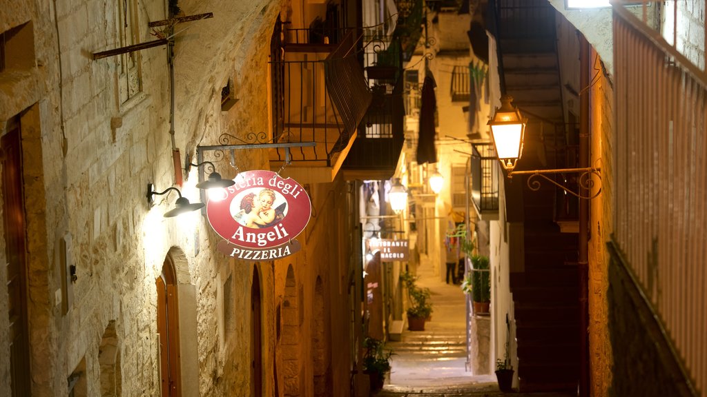 Vieste which includes night scenes and signage