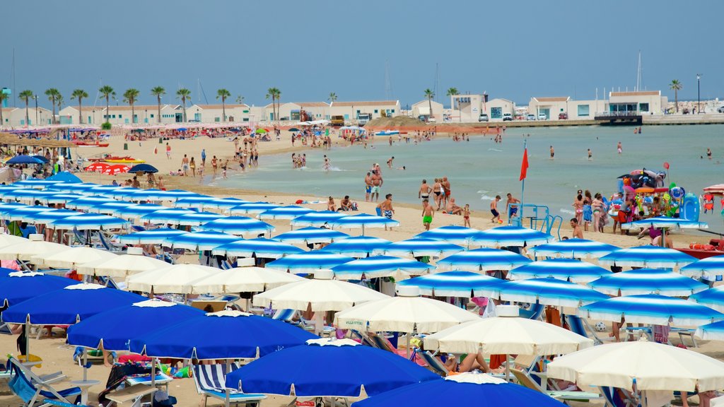 Rodi Garganico which includes general coastal views and a sandy beach as well as a large group of people