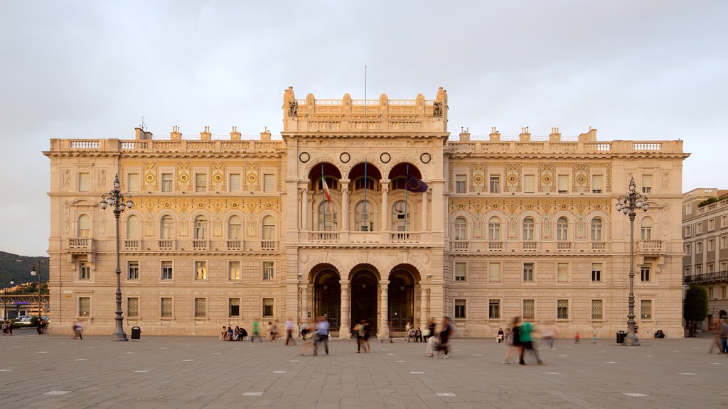 Piazza dell\'Unita featuring an administrative buidling, a sunset and general coastal views