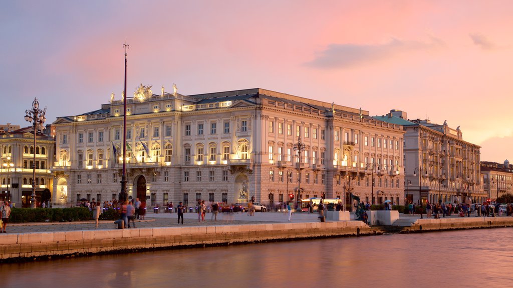 Piazza dell\'Unita que inclui um edifício administrativo, uma praça ou plaza e um pôr do sol