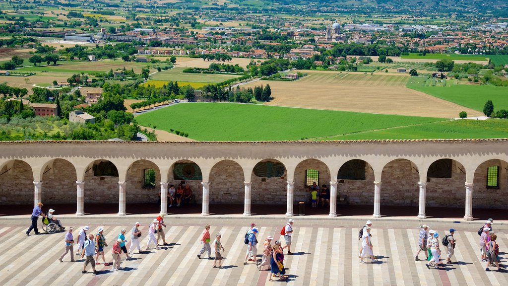 Papal Basilica of St. Francis of Assisi showing landscape views and heritage architecture as well as a large group of people