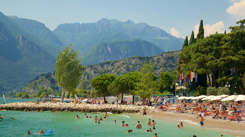 Nago-Torbole showing a beach, a coastal town and mountains