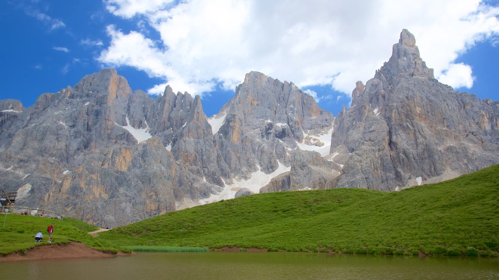 Passo Rolle which includes mountains and a lake or waterhole