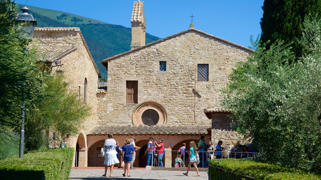 San Damiano featuring heritage architecture as well as a small group of people