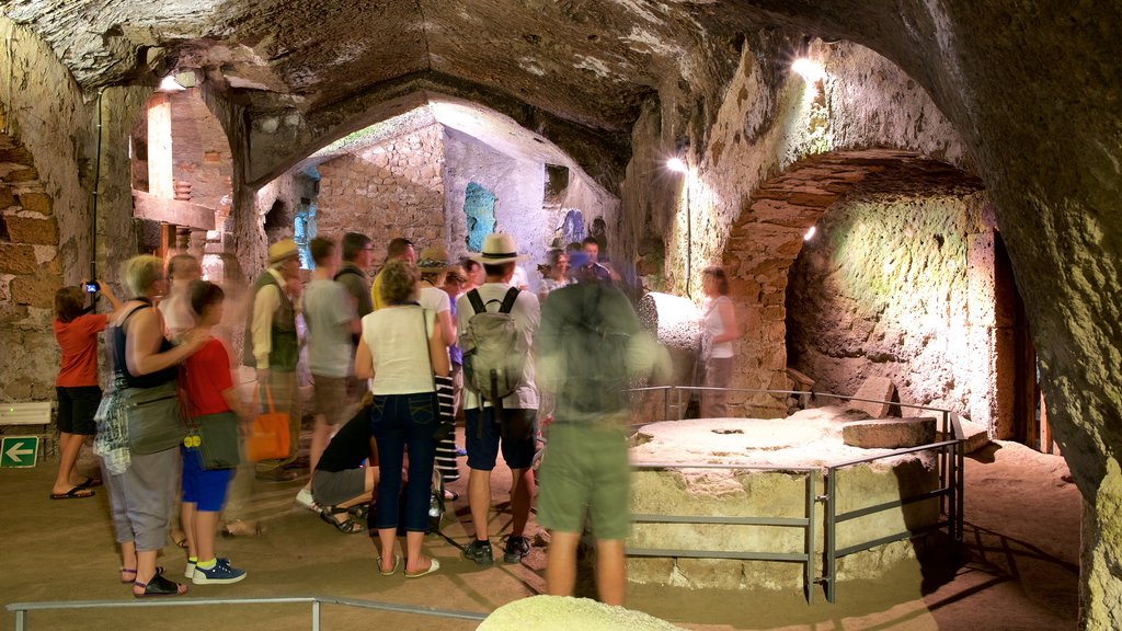 Etruscan Orvieto Underground showing caves and interior views as well as a large group of people