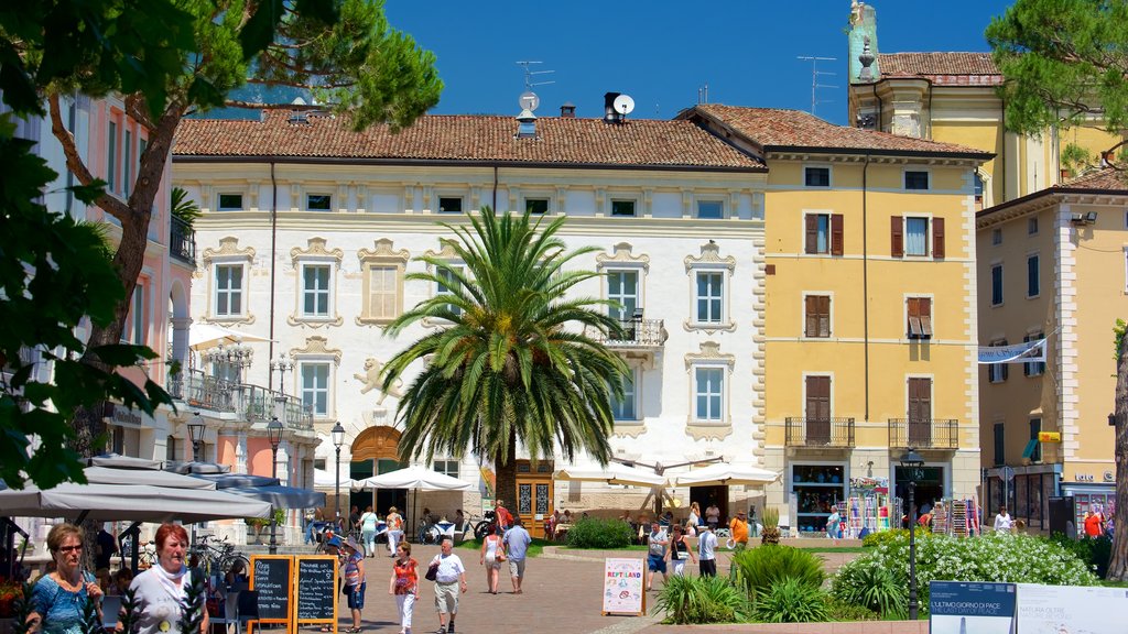 Trentino showing a coastal town as well as a large group of people