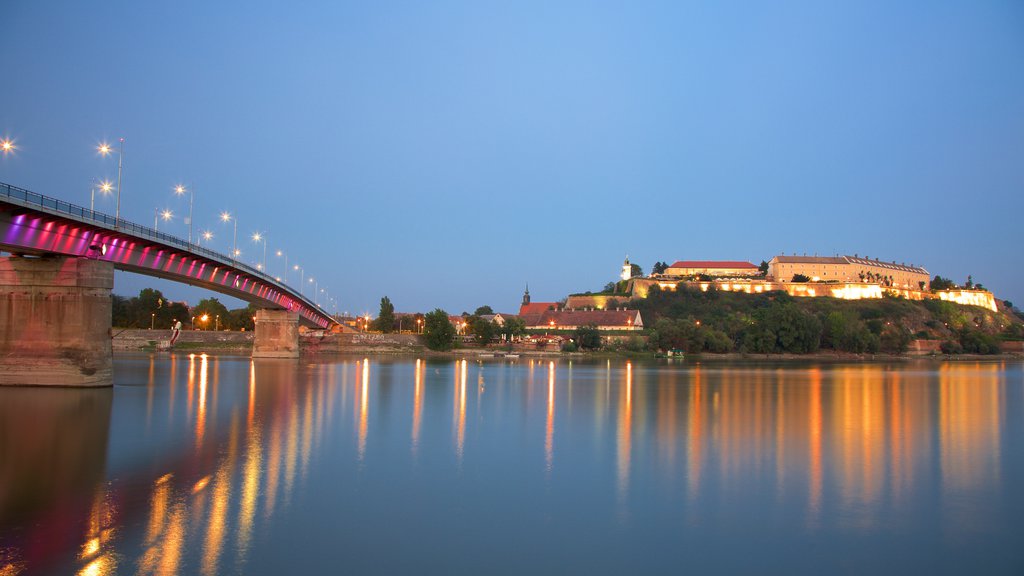 Petrovaradin Fortress showing a river or creek, a bridge and night scenes