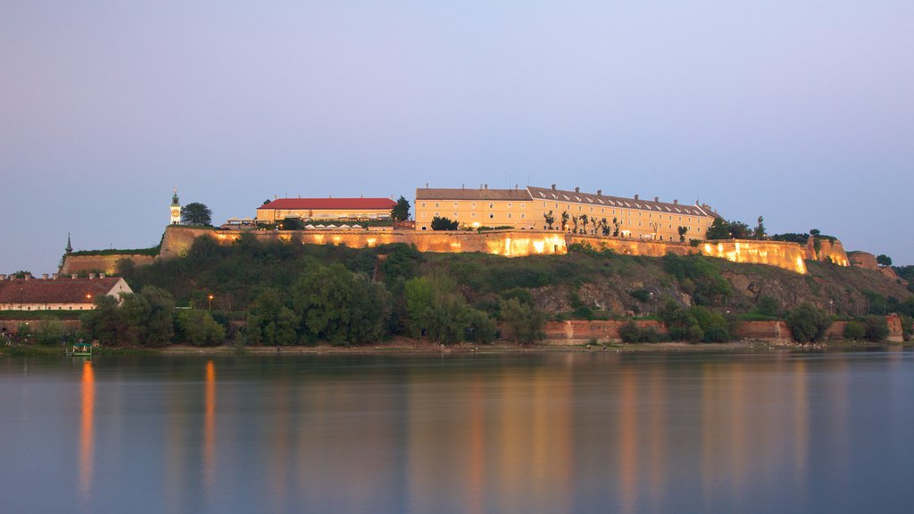 Petrovaradin Fortress showing a river or creek and night scenes