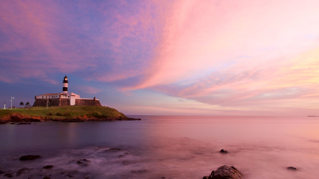 Plage de Farol da Barra mettant en vedette un phare, un coucher de soleil et paysages côtiers