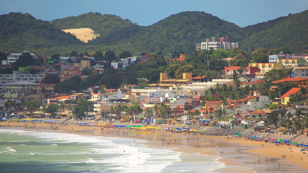 Ponta Negra Beach which includes a sandy beach, a coastal town and swimming