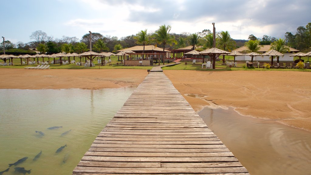 Figueira Beach which includes a sandy beach, a luxury hotel or resort and aircraft