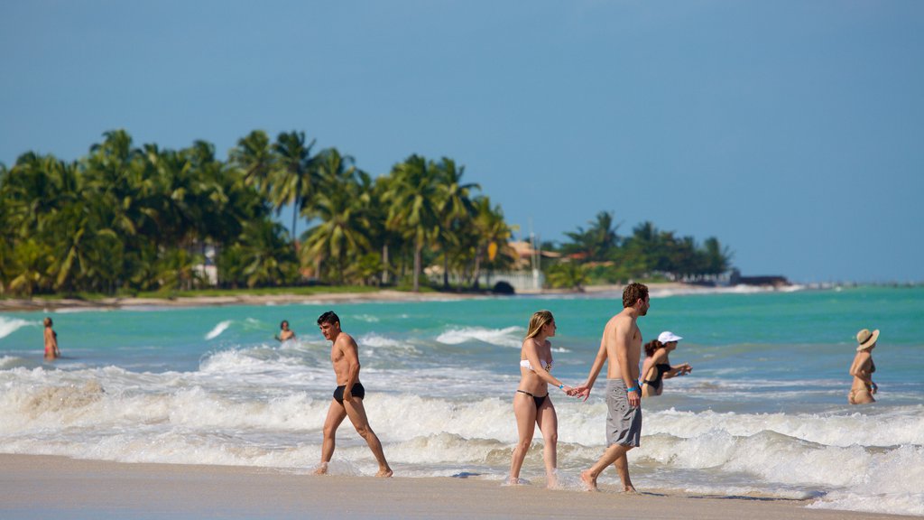 Playa Ipioca ofreciendo natación, vista general a la costa y una playa de arena