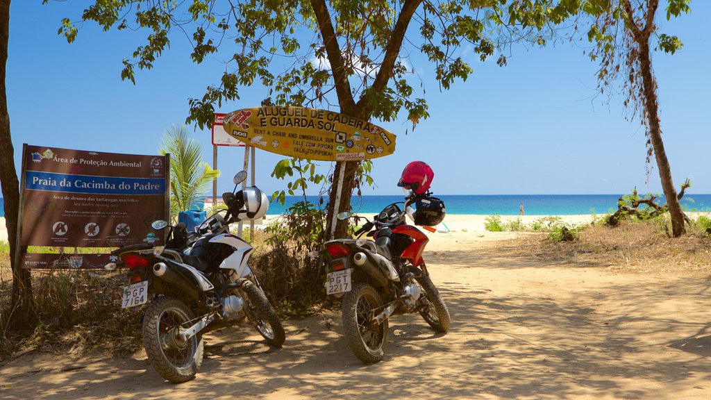 Cacimba do Padre Beach showing motorcycle riding, a sandy beach and signage