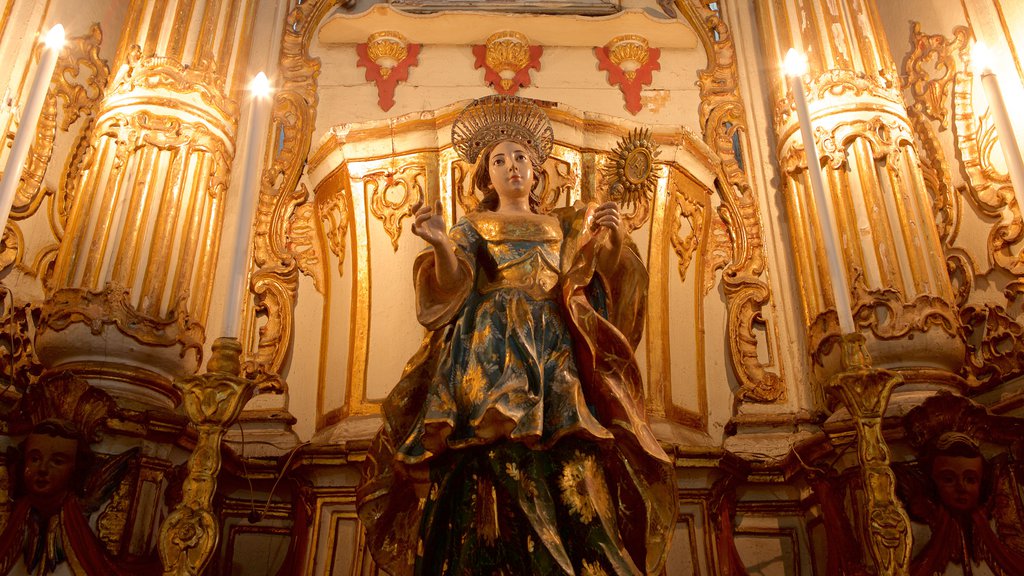 Nossa Senhora de Conceicao da Praia Church showing a statue or sculpture, religious aspects and interior views