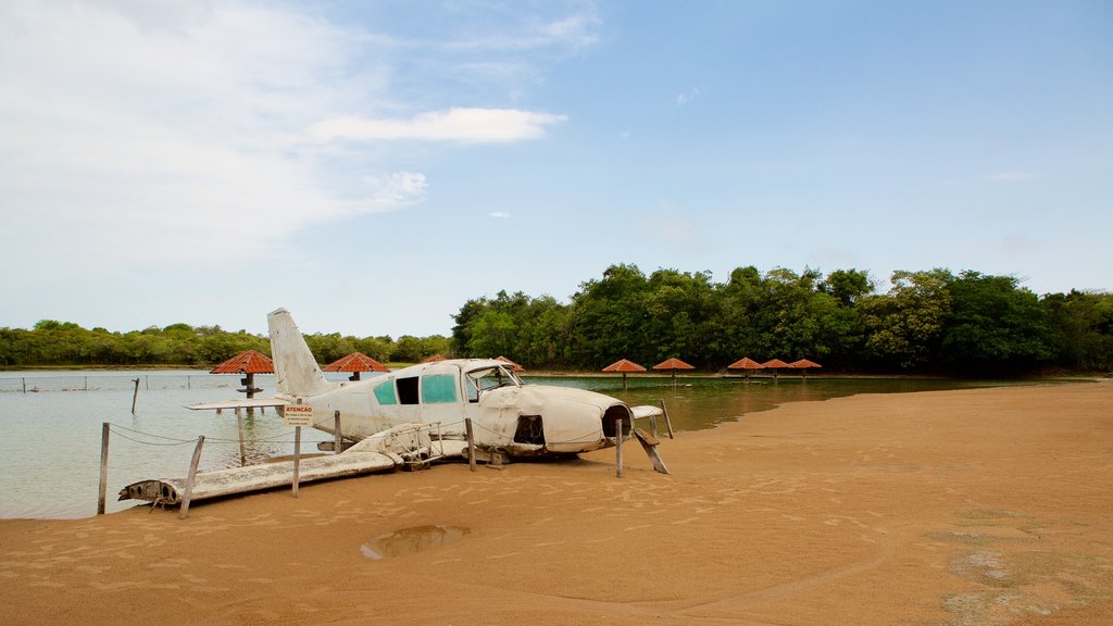 Figueira Beach which includes a beach, aircraft and general coastal views