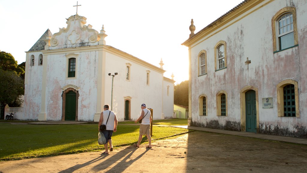 Porto Seguro ofreciendo una iglesia o catedral y elementos patrimoniales y también un pequeño grupo de personas