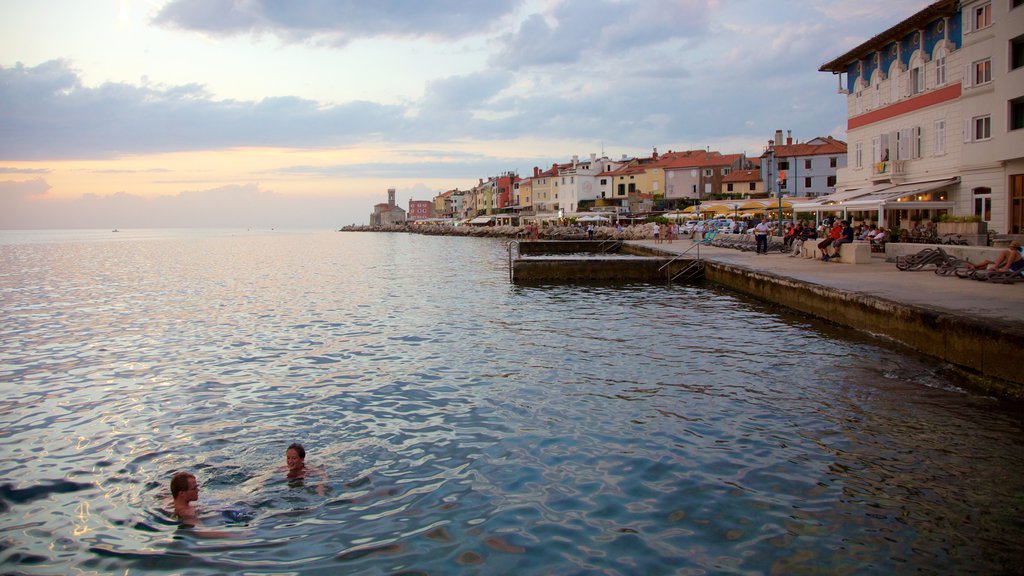 Piran showing a coastal town, swimming and a sunset