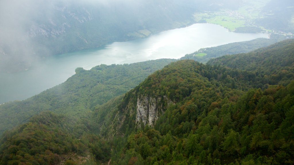 Triglav National Park showing mountains, mist or fog and a lake or waterhole