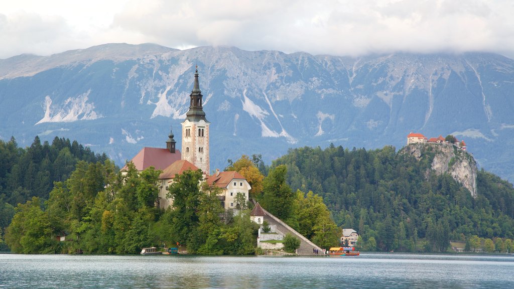 Lake Bled which includes forests, mountains and a small town or village