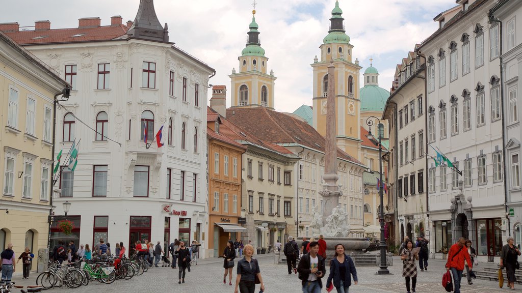 St. Nicholas Cathedral which includes a square or plaza and a church or cathedral as well as a large group of people