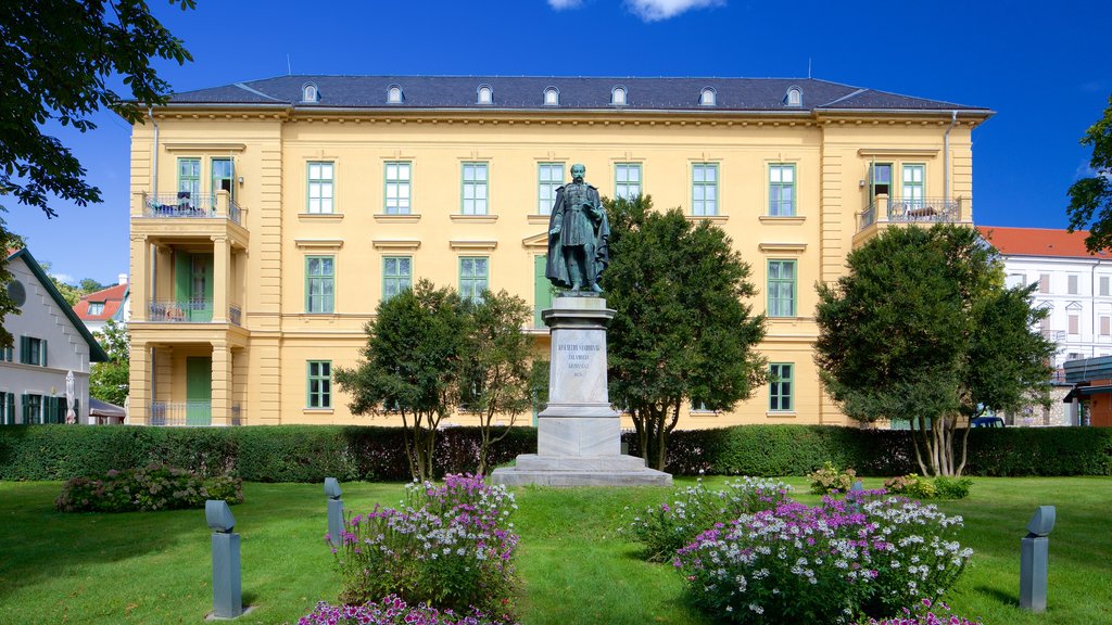 Balatonfured which includes flowers, a statue or sculpture and a park