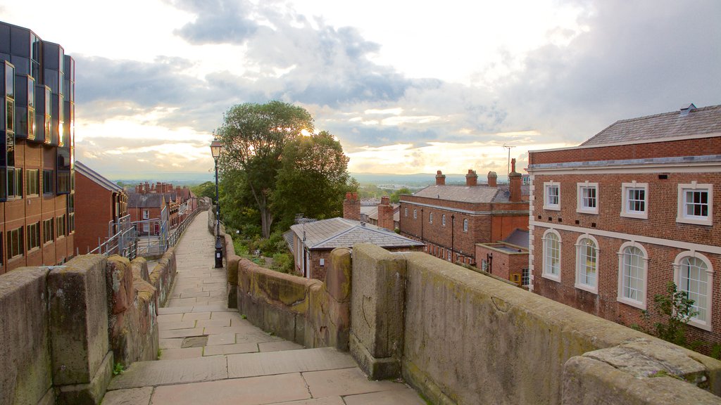 Chester City Walls which includes a bridge, heritage elements and a sunset