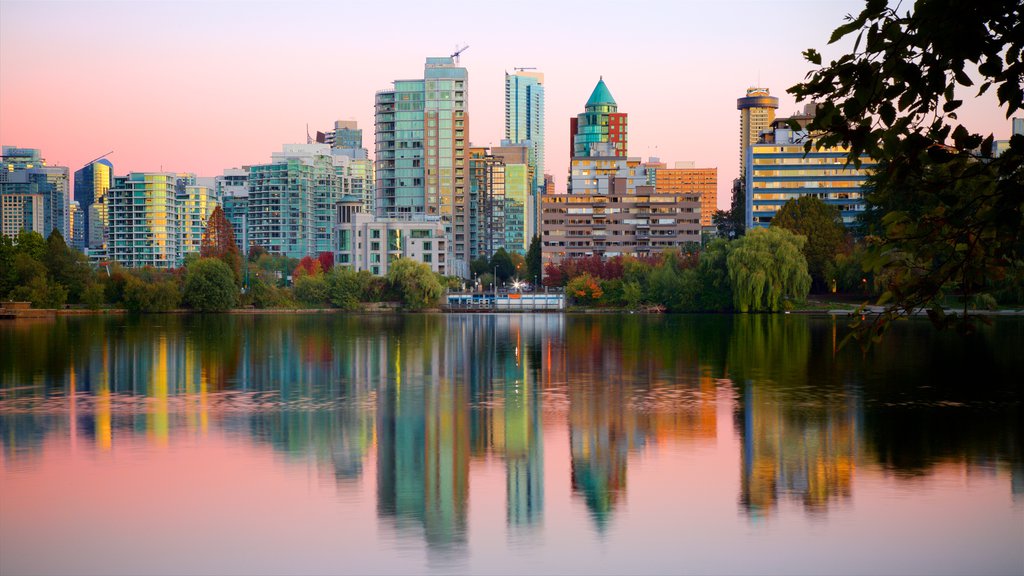 Stanley Park showing a sunset, central business district and a bay or harbor