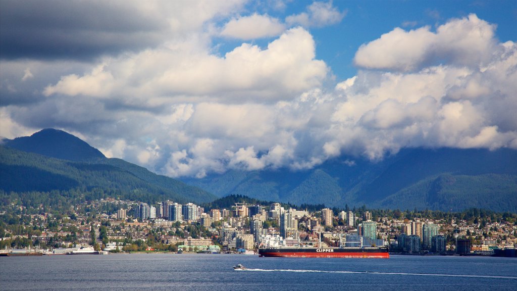 Canada Place showing mountains, a city and a bay or harbour