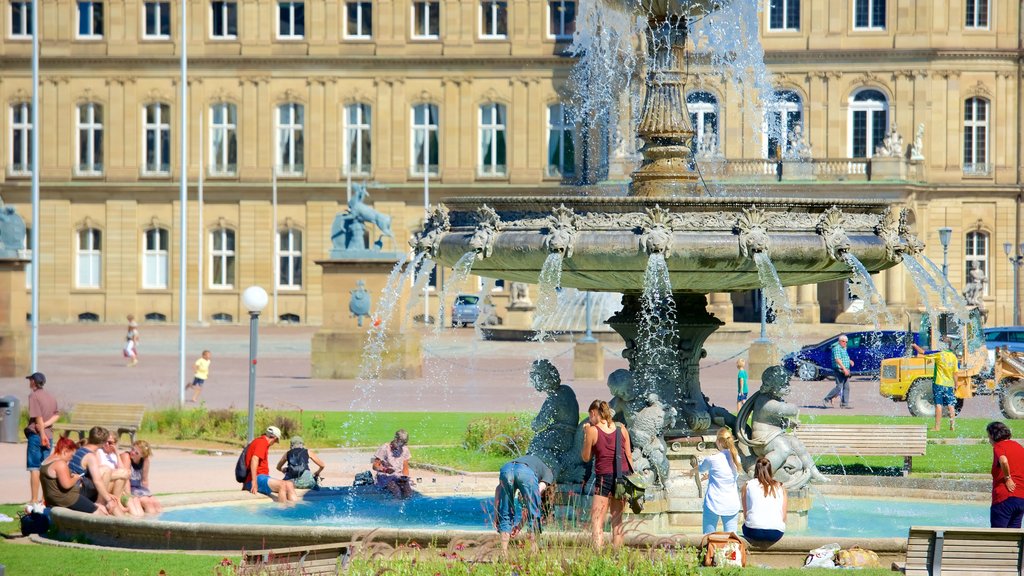 Schlossplatz showing a fountain as well as a small group of people