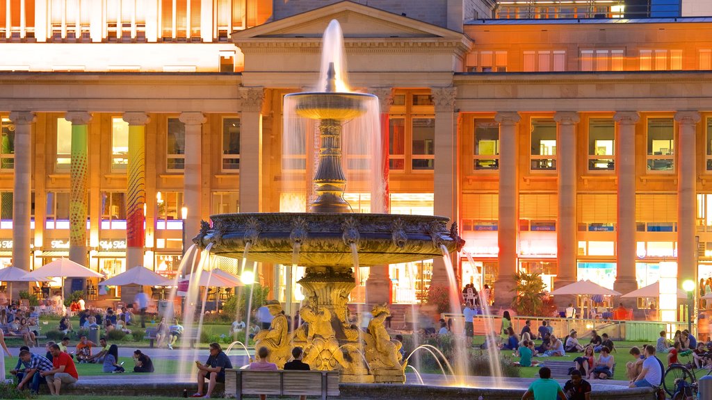 Schlossplatz showing night scenes and a fountain as well as a large group of people