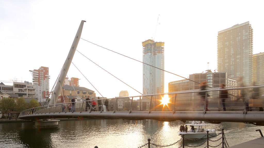 Canary Wharf showing a bridge, a sunset and boating