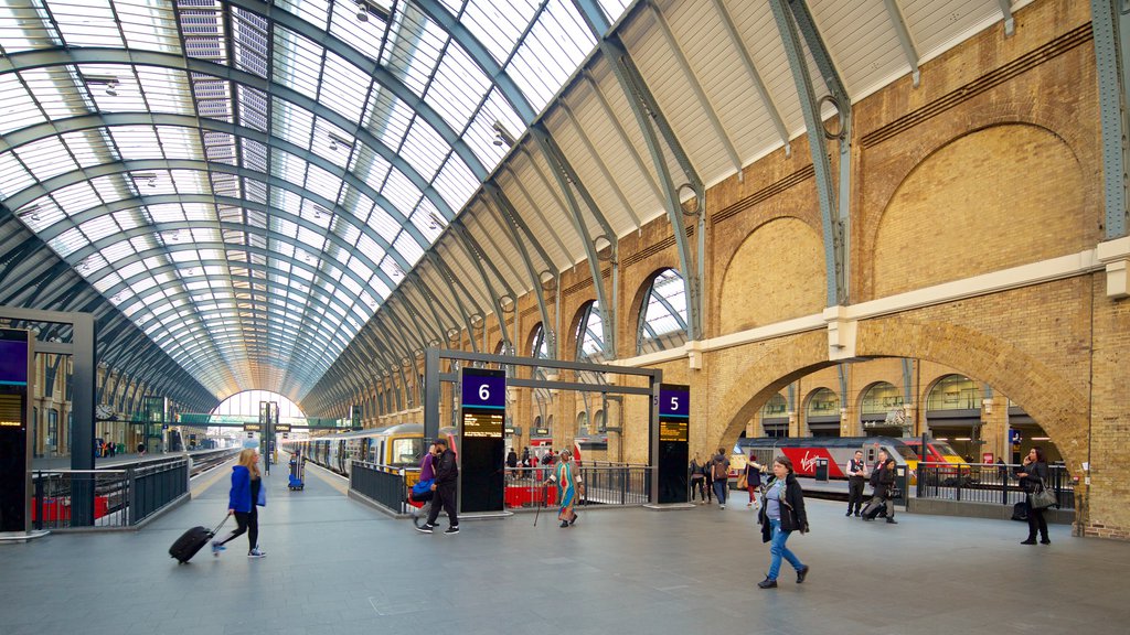 Kings Cross St. Pancras featuring heritage architecture and interior views as well as a small group of people