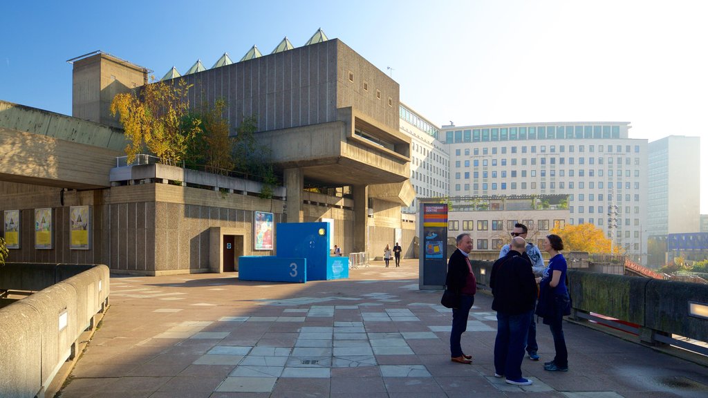 Southbank Centre showing theater scenes and modern architecture as well as a small group of people