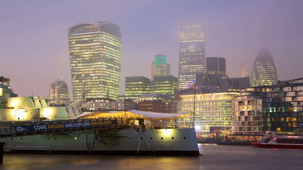 HMS Belfast showing mist or fog, a river or creek and a high-rise building