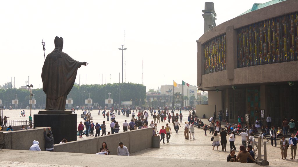 Basilica of Our Lady of Guadalupe showing a church or cathedral, religious elements and a statue or sculpture