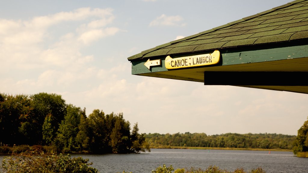 Peterborough which includes signage, forests and a lake or waterhole