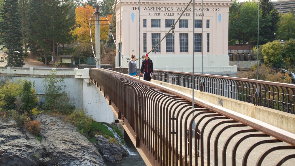 Riverfront Park showing a bridge and heritage architecture as well as a couple