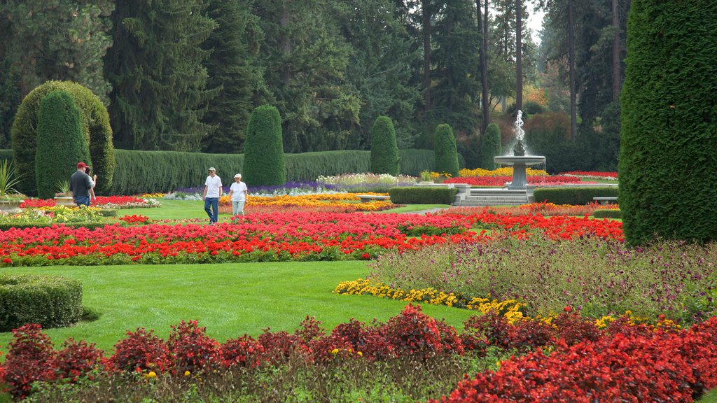 Manito Park which includes a garden and a fountain as well as a small group of people