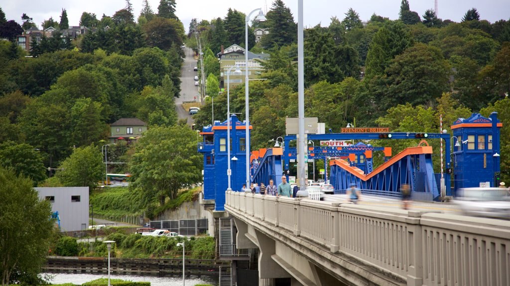 Fremont Bridge showing a river or creek and a bridge as well as a small group of people