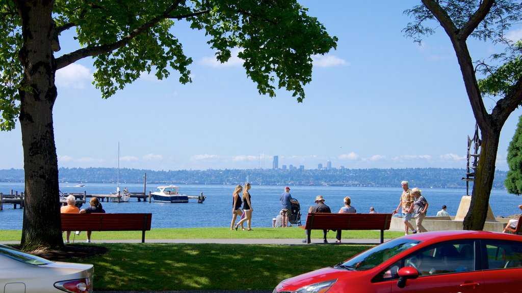 Marina Park showing general coastal views and a bay or harbor as well as a small group of people