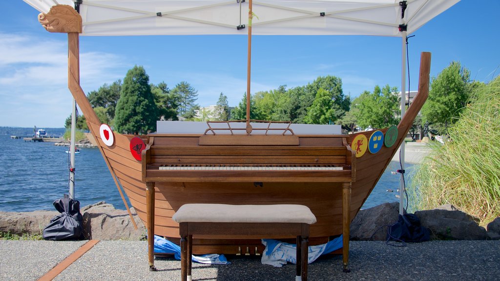 Marina Park showing outdoor art, a bay or harbor and music